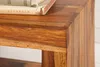 A close-up view of a wooden table corner with a book on top. Produktbild-Vorschau