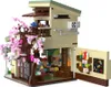 A detailed Lego-style model of a Japanese-inspired building with a cherry blossom tree. Produktbild-Vorschau
