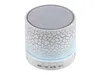 A white cylindrical Bluetooth speaker with a cracked texture and a mesh top, set against a white background. Produktbild-Vorschau