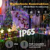 Outdoor Christmas lights decoration on a house and garden during rain. Produktbild-Vorschau
