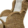 A close-up view of a wicker armchair and ottoman with white cushions. Produktbild-Vorschau