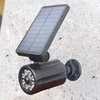 A solar-powered LED light with a motion sensor and dummy camera attached to a speckled stone wall. Anteprima dell’immagine prodotto