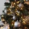A close-up view of a decorated Christmas tree with ornaments and lights. Produktbild-Vorschau