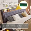 A bed with a headboard featuring integrated lighting and charging ports, decorated with pillows and decorative items. Náhľad obrázku produktu