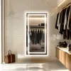 A modern closet with a lighted mirror and clothing on racks. Podgląd zdjęcia produktu