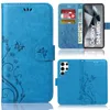 A collage of images showing a blue flip phone case with a floral and butterfly design, including a view of the inside with card slots and a phone display. Produktbild-Vorschau