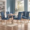 A dining room scene with a wooden table and blue upholstered chairs. Produktbild-Vorschau