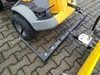A close-up view of a snow plow attachment for a ride-on mower, shown on a paved surface. Produktbild-Vorschau