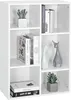A white bookshelf filled with books and decorative items. Voir les images du produit