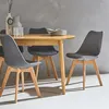 A dining table with chairs in a modern setting. Produktbild-Vorschau