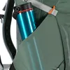 A close-up view of a teal water bottle in a side pocket of a green backpack. Produktbild-Vorschau