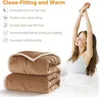 A woman stretching in bed next to folded blankets, with text describing the blanket's features. Produktbild-Vorschau