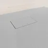 A close-up view of a gray shower tray with a rectangular drain cover. Produktbild-Vorschau