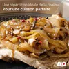 A close-up of food, likely meat with caramelized onions, in a pan. Produktbild-Vorschau