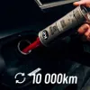 A hand is pouring a liquid from a can into a car's fuel tank. Podgląd zdjęcia produktu