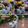 A collage of three images showing a garden cat statue with a gnome and lantern, highlighting its features in different conditions. Produktbild-Vorschau