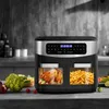 A modern air fryer with two transparent compartments, one containing a roasted chicken and the other french fries, sits on a countertop with fresh vegetables in the foreground. Produktbild-Vorschau
