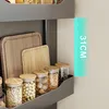 A kitchen shelf with storage jars and cutting boards, with a ruler overlay indicating height. Anteprima dell’immagine prodotto