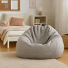 A cozy bedroom scene with a bed, a beanbag chair, and a nightstand. Anteprima dell’immagine prodotto