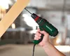 A hand holding a green and black Parkside drill, drilling into a wooden plank. Produktbild-Vorschau
