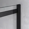 A close-up view of a black framed shower enclosure with clear glass against a textured gray wall. Produktbild-Vorschau