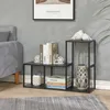 A living room scene with a sofa, a set of black metal shelving units, books, and decorative items. Anteprima dell’immagine prodotto