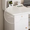 A close-up view of the rounded corner of a white desk, highlighting its smooth finish and subtle design elements. Náhled obrázku produktu