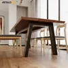 A dining table and chairs in a well-lit room. Produktbild-Vorschau