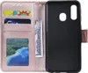 A pink flip phone case with card slots and a money slot is shown open, revealing the inside compartments and the black phone holder. Produktbild-Vorschau
