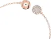 A close-up of a rose gold bracelet with a circular charm encrusted with small white stones and a magnified view of the clasp mechanism. Produktbild-Vorschau