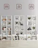 Three white bookshelves filled with various decorative items and storage boxes, with illustrative icons above each shelf. Náhled obrázku produktu
