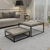A living room scene with a sofa, coffee tables, and a window view. Produktbild-Vorschau