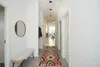 A modern hallway with a bench, mirror, and a runner rug. Podgląd zdjęcia produktu