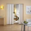 A room with a folding door, a table with apples, and a chair. Produktbild-Vorschau