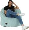 A woman is sitting on a beanbag chair. Náhľad obrázku produktu