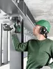 A construction worker is using a power tool on a metal structure. Voir les images du produit