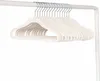 A group of cream-colored hangers are neatly arranged on a white clothing rack. Anteprima dell’immagine prodotto