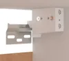 Close-up view of a white cabinet bracket and mounting hardware, attached to a white surface. The bracket has multiple oval-shaped holes. Voir les images du produit
