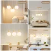 A collage of four images showing a pendant light fixture in different room settings: living room, bedroom, dining room, and kitchen. Voir les images du produit
