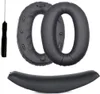 A set of black ear pads and a headband for headphones, along with a small tool, are displayed against a white background. Voir les images du produit