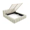 A beige upholstered bed frame with the mattress support slats lifted, revealing the storage compartment underneath. Produktbild-Vorschau