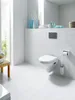 A clean, modern bathroom with a wall-mounted toilet and tiled walls. Produktbild-Vorschau