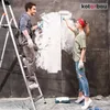 A man and a woman are painting a wall white. Produktbild-Vorschau