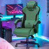 A gaming chair is set up next to a computer desk with a monitor and PC tower, illuminated by colorful LED lights. Produktbild-Vorschau
