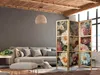 A living room scene with a sofa, ottoman, and a decorative room divider. Náhled obrázku produktu