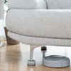 A robot vacuum cleaner is cleaning under a sofa that is raised by anti-vibration feet. Anteprima dell’immagine prodotto