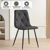 A dark gray upholstered dining chair with a diamond pattern on the backrest and black metal legs, set against a light-colored wall and a white shelving unit. Náhled obrázku produktu