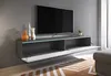 A modern living room with a wall-mounted TV cabinet and a large television. Anteprima dell’immagine prodotto
