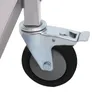 A close-up view of a caster wheel with a brake mechanism attached to a metal leg of a trolley. Voir les images du produit