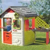 A young child is playing in a colorful outdoor playhouse. Produktbild-Vorschau